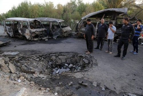 People gather at the site of a car bomb attack in Baghdad