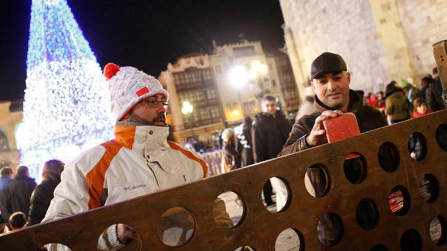 Varias personas en la Plaza Mayor de Zamora, decorada por Navidad.