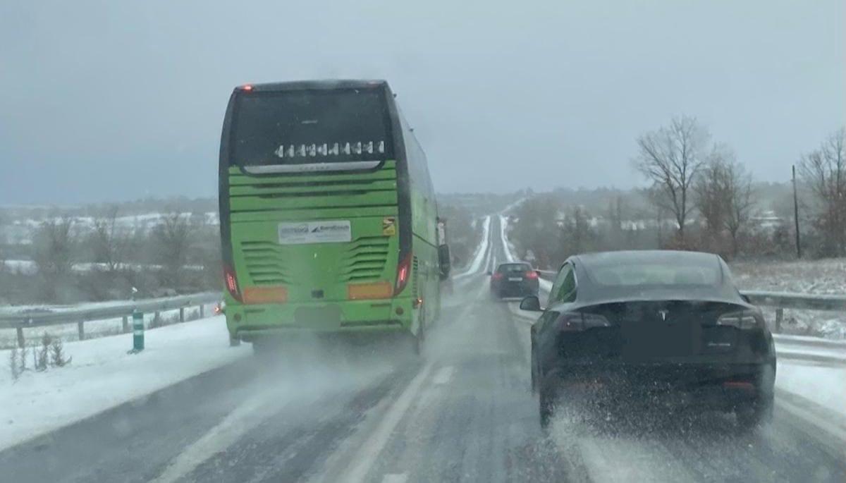 Un autobús adelanta a dos turismos en uno de los días de temporal en la N-122.