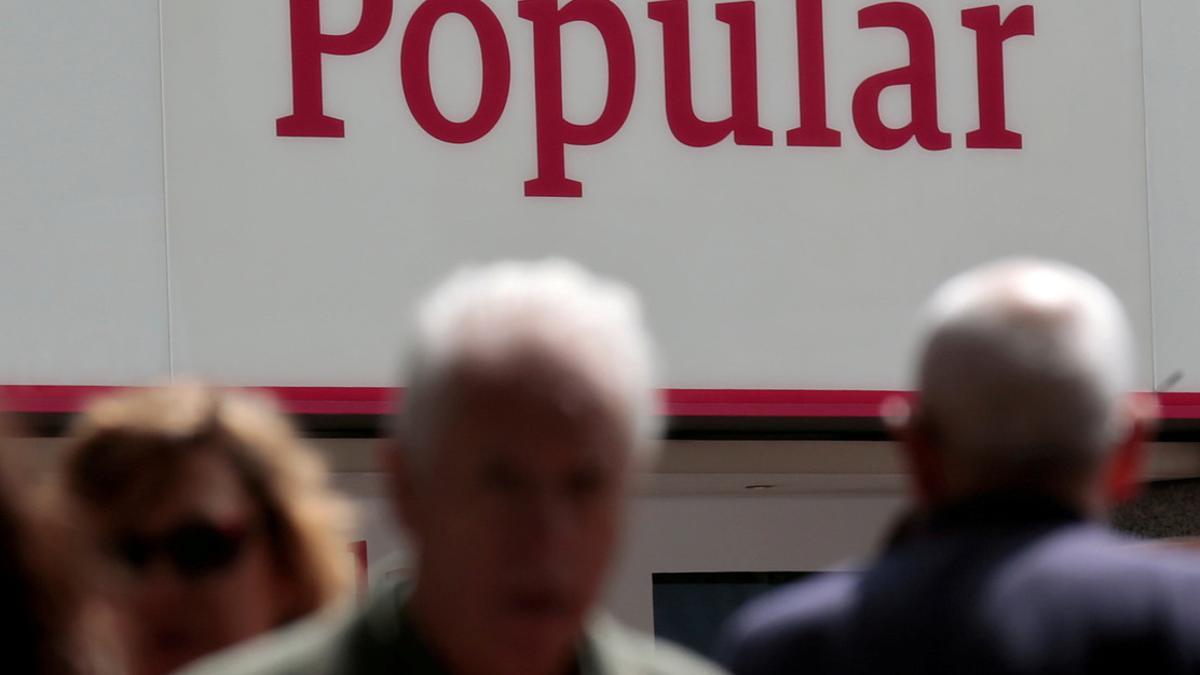 FILE PHOTO: People walk past a branch of Spain's Banco Popular in Madrid