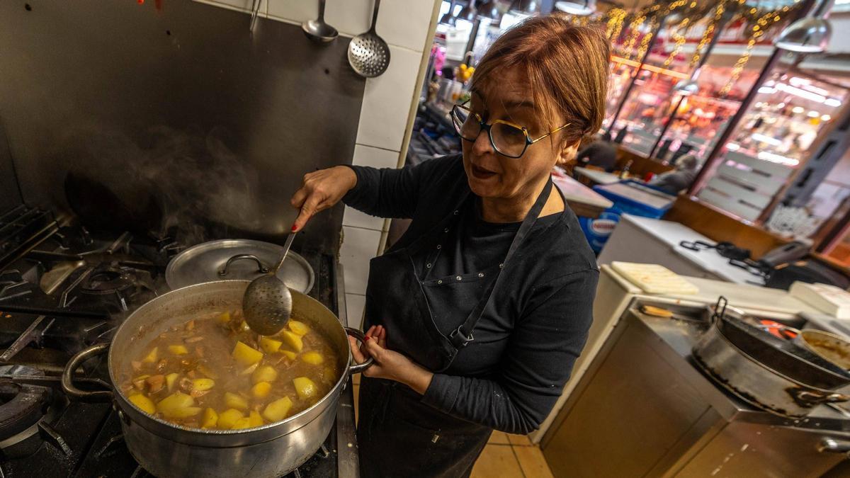 Germina Sánchez Mercadé, dueña del Bar del Mercat, en el Mercat del Centre de Vilanova i la Geltrú, cocinando.