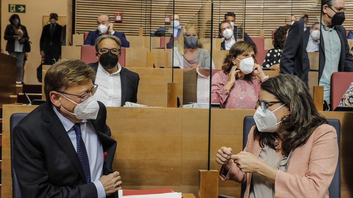 El president Ximo Puig conversa con Oltra durante un pleno del Consell.