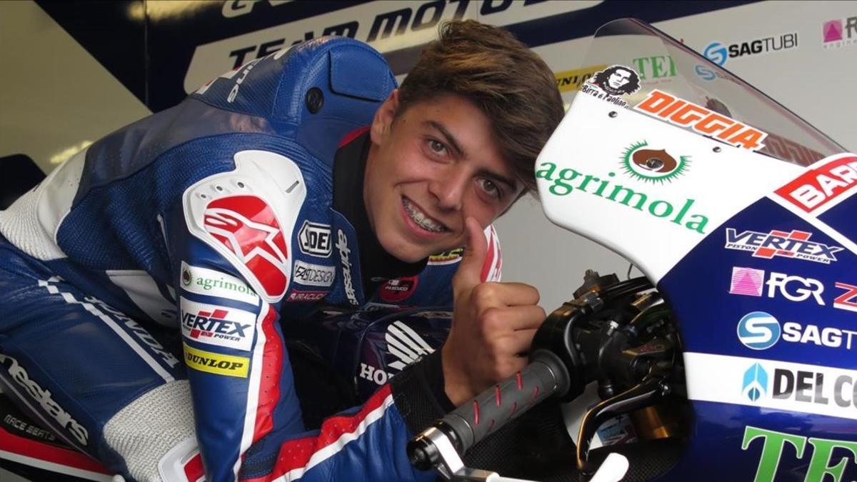 Fabio Di Giannantonio, joven piloto italiano de 17 años, sonríe subido en la Honda del equipo del campeón Fausto Gresini, en su box de Misano.