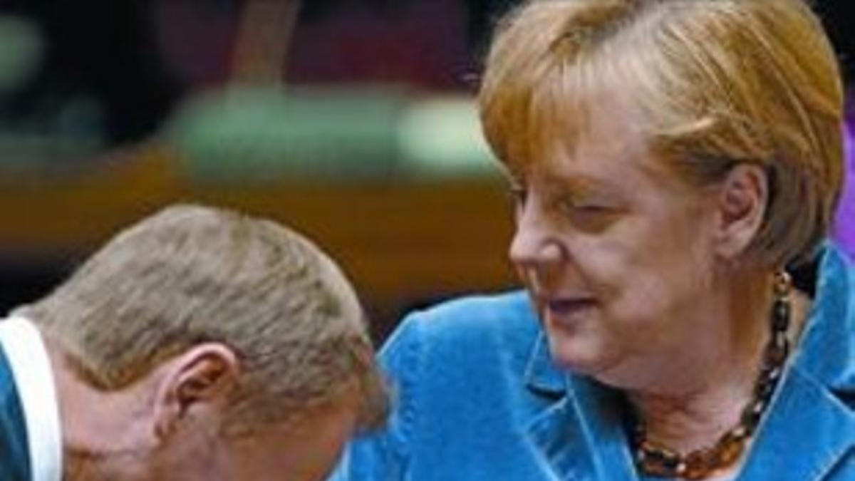 El primer ministro polaco, Donald Tusk, besa la mano de la cancillera alemana, Angela Merkel, el miércoles.