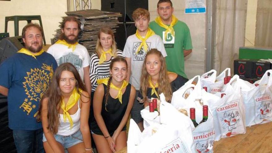 Miembros de la comisión y voluntarios ayer, en el reparto del bollu. Por la izquierda, de pie, Falu Ledo, Carlos Álvarez, Lucía Miravalles, Diego Fernández y Alejandro González. Sentadas, Carla Delgado, Carla Díaz y María Cortés.