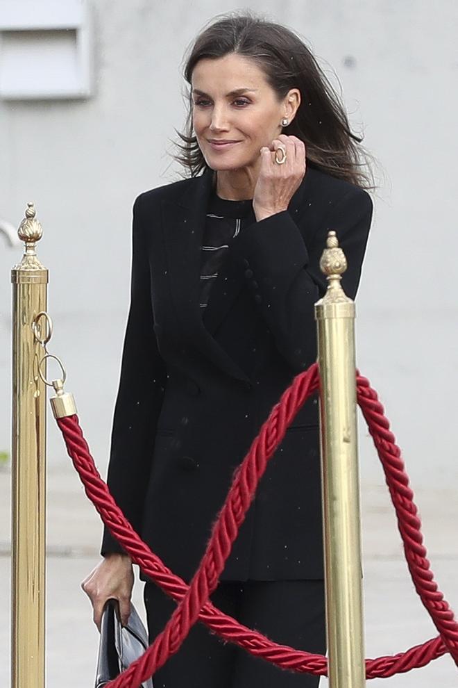 La Reina Letizia con traje negro y top a rayas