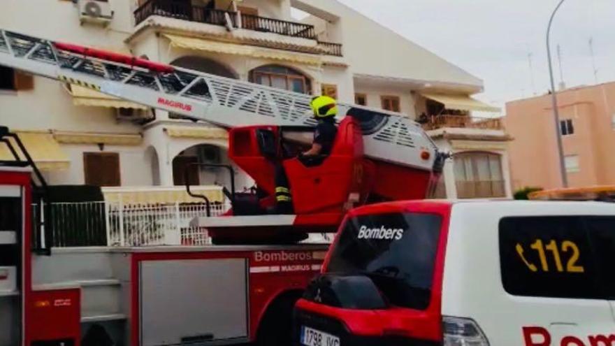 Los bomberos acceden con el vehículo escalera a la vivienda donde se ha producido el incendio