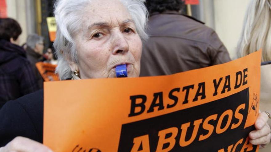 Una mujer protesta ante la sede del Banco de España en Valencia.