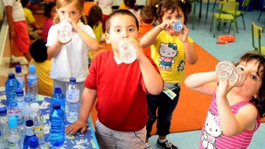 Los niños superan el calor de las clases consumiendo agua embotellada.