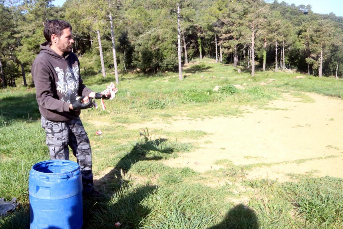 Un membre de la fundació Pioners de la Natura deixant menjar a la zona.