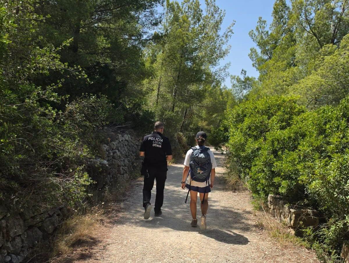 Una agente acompaña a una de las senderistas que se extravió en el Montgó