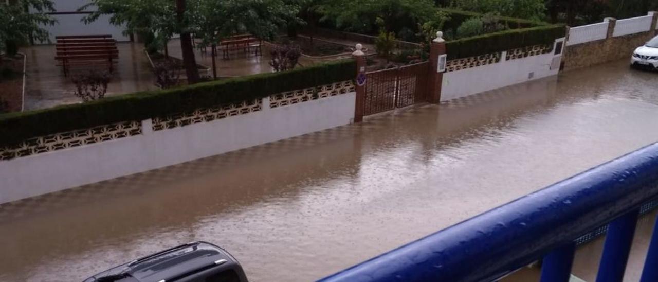 Una calle de la playa de Bellreguard inundada tras un episodio de fuertes lluvias y, a la derecha, dos de las nuevas bombas extractoras instaladas en el sistema.                                    levante-emv