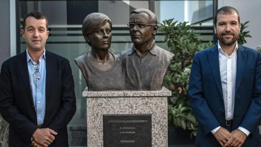 Ángel (a la izquierda) y José Escribano, en la sede del grupo, con un busto dedicado a sus padres. | EM&E