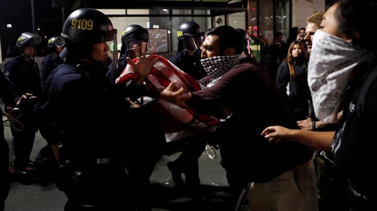 jgblanco36241403 a masked demonstrator scuffles with police officers during a161111120510