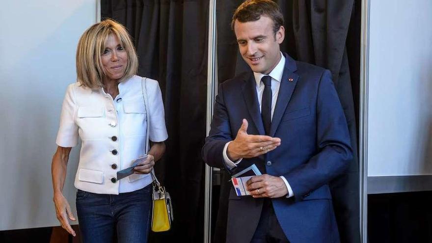 Macron y su esposa, Brigitte Trogneux, ayer, después de votar en París. // Reuters