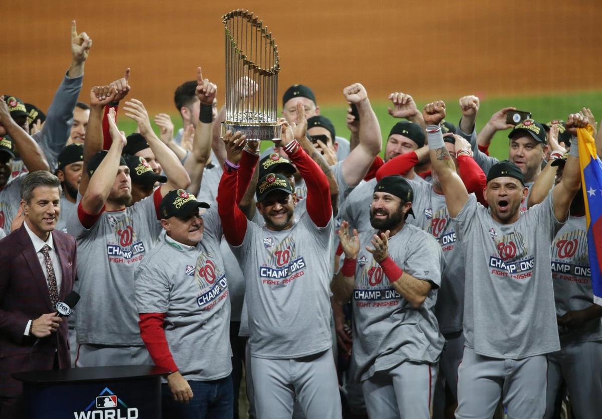 Oct 30, 2019; Houston, TX, USA; Washington Nationals manager Dave Martinez (4) and general manager Mike Rizzo hoist the Commissioners Trophy after defeating the Houston Astros in game seven of the 2019 World Series at Minute Maid Park. The Washington Nationals won the World Series winning four games to three.  Mandatory Credit: Thomas B. Shea-USA TODAY Sports