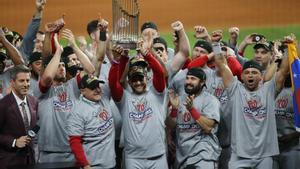 Oct 30, 2019; Houston, TX, USA; Washington Nationals manager Dave Martinez (4) and general manager Mike Rizzo hoist the Commissioners Trophy after defeating the Houston Astros in game seven of the 2019 World Series at Minute Maid Park. The Washington Nationals won the World Series winning four games to three.  Mandatory Credit: Thomas B. Shea-USA TODAY Sports