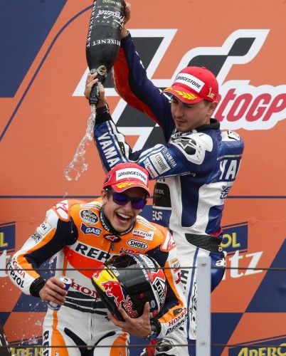 Yamaha MotoGP rider Lorenzo sprays champagne at compatriot Honda rider Marquez as he celebrates on the podium after winning the San Marino Grand Prix in Misano circuit