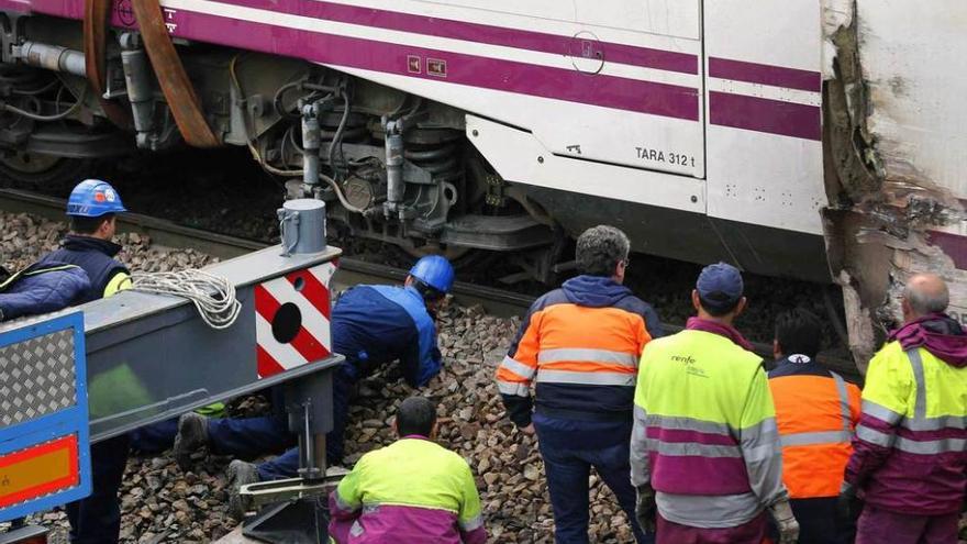 Sobre estas líneas, los técnicos examinan el tren descarrilado. A la derecha, arriba, los pasajeros Agustín Falcón, Elena Ronzón y Gabriela Saralegui, tras llegar a la estación de Oviedo. Debajo, varios pasajeros descienden del tren a las dos y cuarto de la madrugada.