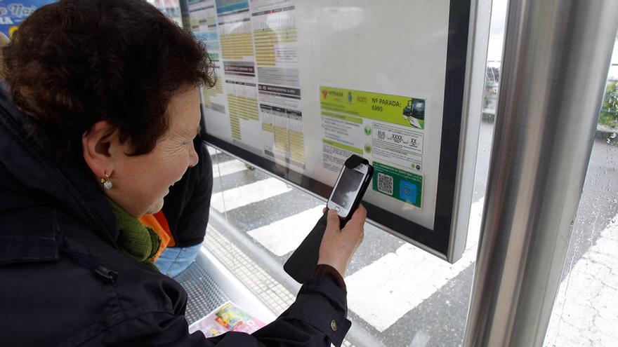 Una usuaria de Vitrasa consultan con el móvil el horario de su bus. // R.G.