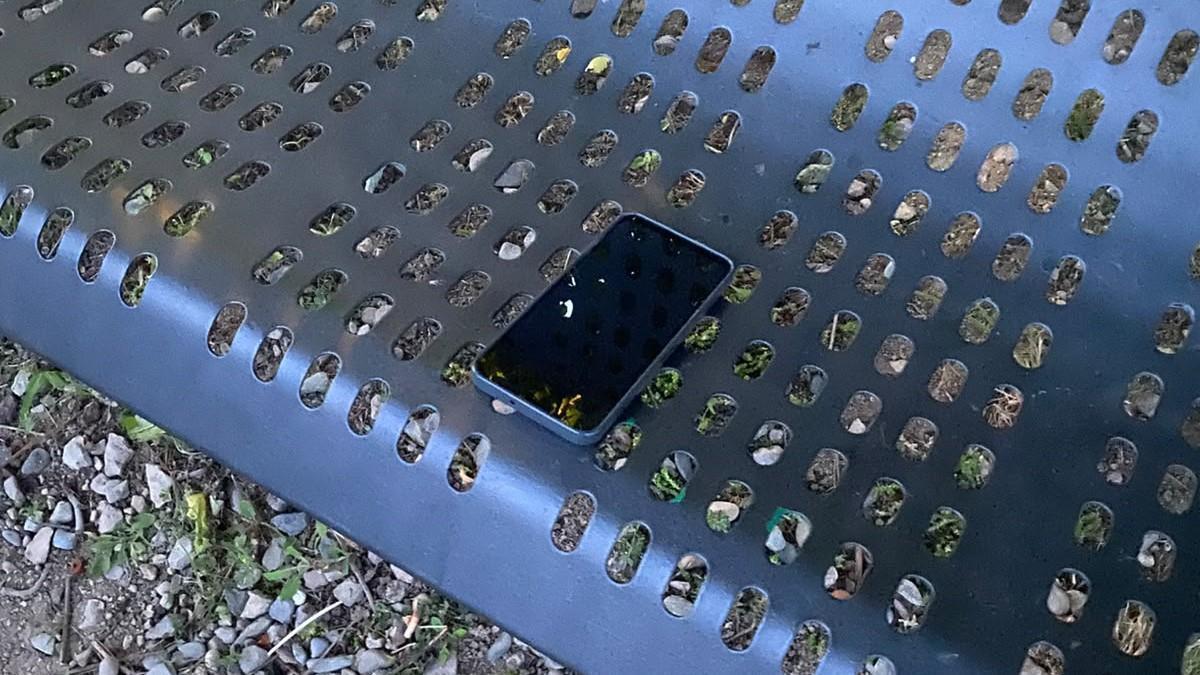 El telèfon mòbil oblidat en un banc públic