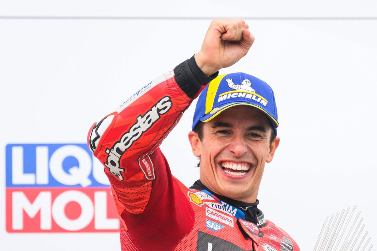 Winner Marc Marquez from Spain from the Ducati Lenovo Team celebrates on the podium following the MotoGP race, German Grand Prix, at the Sachsenring circuit, in Hohenstein-Ernstthal, Germany, Sunday July 13, 2025. (Robert Michael/dpa via AP). GERMANY OUT; MANDATORY CREDIT