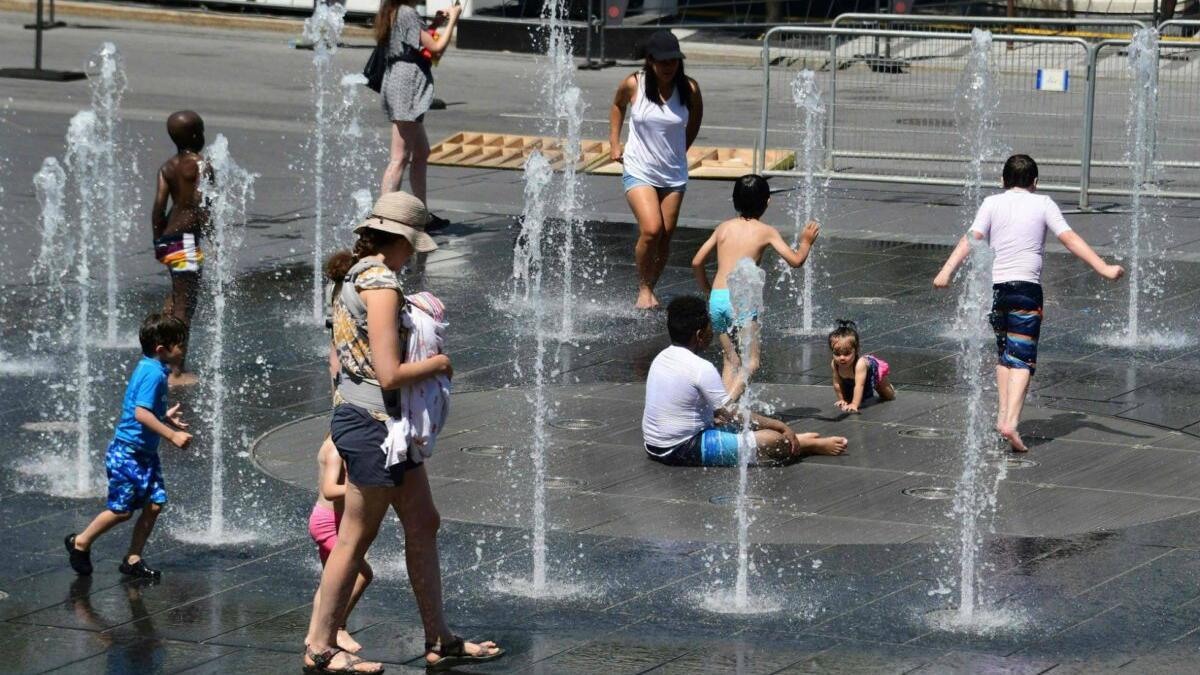 Personas en la calle tratando de combatir la ola de calor