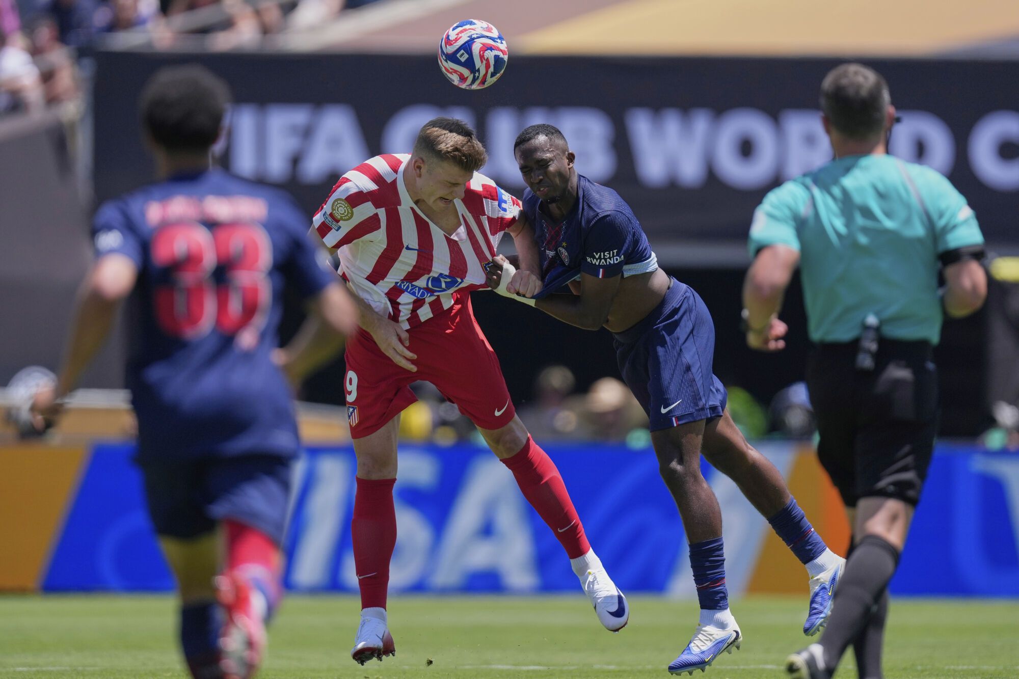 Atletico Madrid's Alexander Sorloth, left, goes for a header with Paris Saint-Germain's Willian Pacho during the Club World Cup group B soccer match between PSG and Atletico Madrid, in Pasadena, Calif., Sunday, June 15, 2025. (AP Photo/Mark J. Terrill)