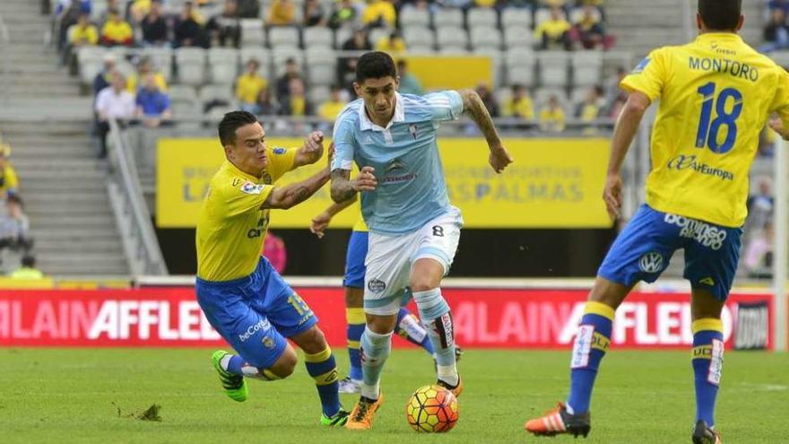 Pablo Hernández avanza con la pelota entre Roque Mesa y Montoro.  // LOF