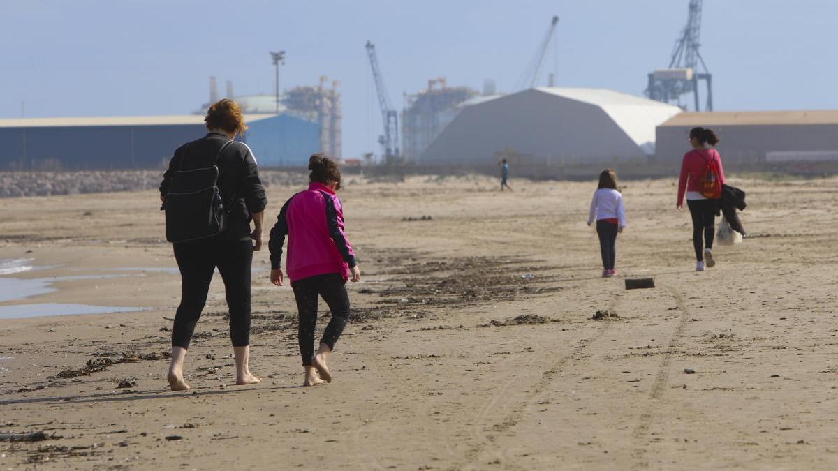 Personas paseando por la playa del Port, al reabrirse el acceso.