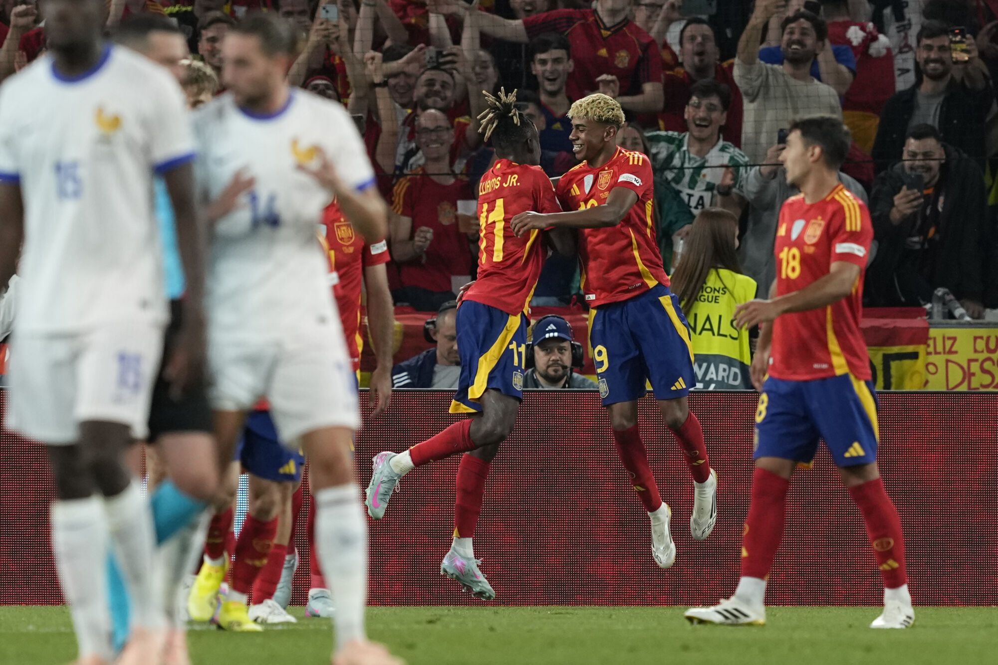 Spain's Lamine Yamal, right, celebrates after scoring his side's third goal against France during the Nations League semifinal soccer match between Spain and France at the MHPArena, in Stuttgart, Germany, Thursday, June 5, 2025. (AP Photo/Martin Meissner)