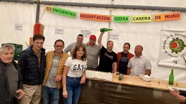 Varios miembros de la directiva de la Asociación Escueles de Muñó, con elaboradores de sidra y otros vecinos, en una edición anterior.