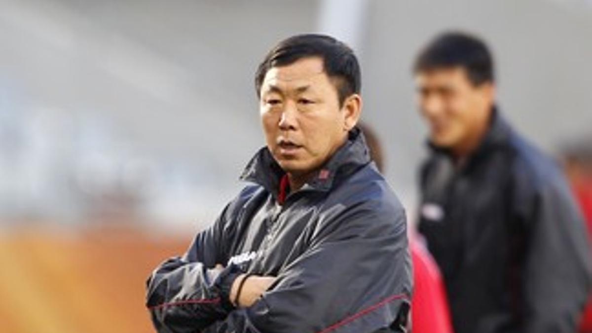 North Korea's coach Kim Jong-hun watches his side train at the Green Point stadium in Cape Town