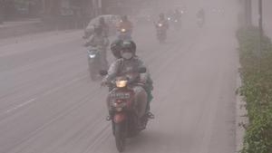 La gente viaja en un camino cubierto por cenizas de la erupción del volcán Monte MerapiÊ de Indonesia, en Magelang.