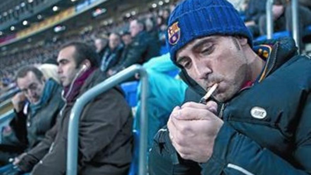 Un espectador enciende un cigarrillo en un partido en el Camp Nou, el pasado mes de enero.