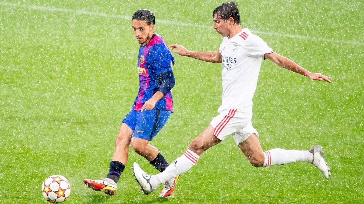 Txus Alba intenta llevarse el balón bajo la intensa lluvia