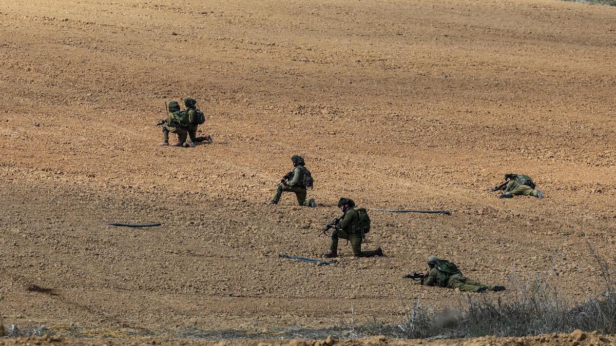 Israeli soldiers take position at Kibbutz Kfar Aza, in southern Israel