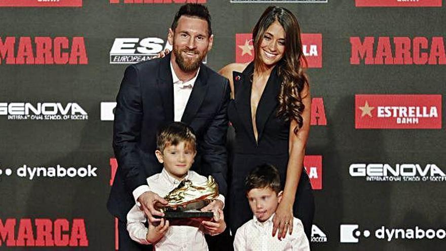 El delantero del Barcelona luce el trofeo en compañía de su esposa y de dos de sus hijos.