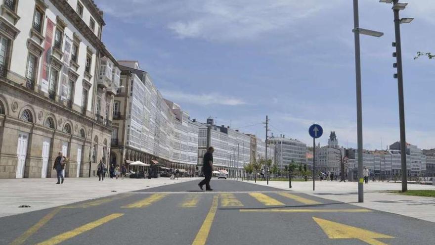 Un hombre cruza un paso de peatones de la Marina, a la altura del teatro Rosalía de Castro.