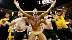 Olympic swimmer Michael Phelps, center, performs behind the Curtain of Distraction during an Oregon State free throw against Arizona State in the second half of an NCAA college basketball game, Thursday, Jan. 28, 2016, in Tempe, Ariz. (AP Photo/Matt York)