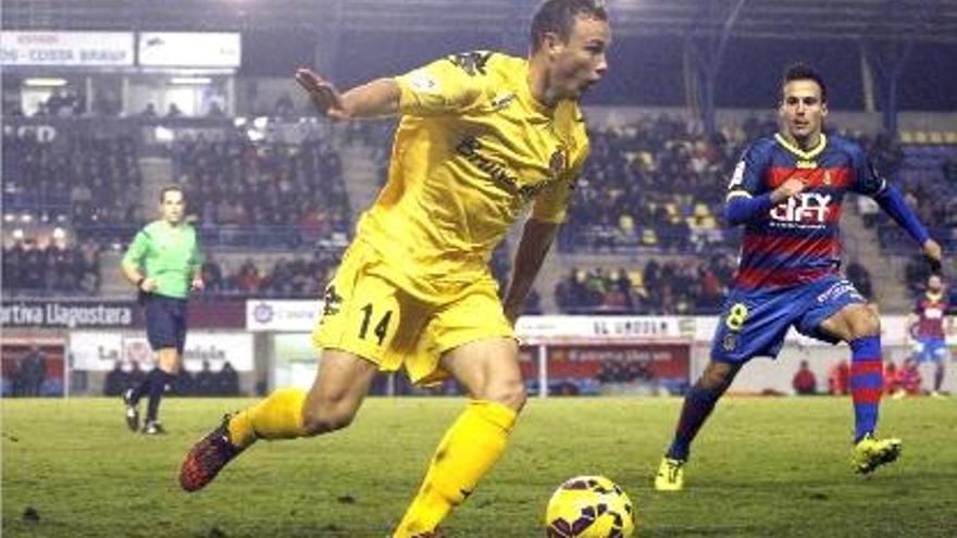 Pablo Íñiguez controla una pilota davant Pitu en el derbi contra el Llagostera a Palamós.