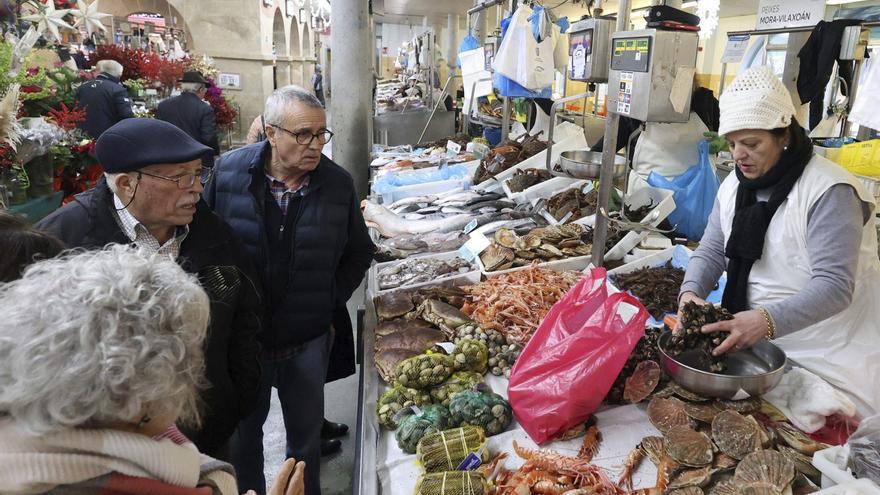 Mary Iglesias atiende a los clientes en su puesto del mercado.