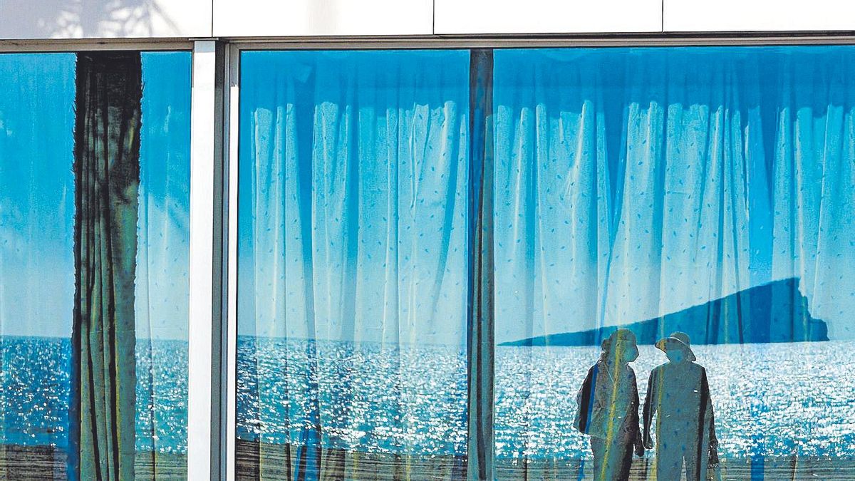 The island of Benidorm reflected in the facade of a restaurant. The island of Benidorm reflected in the facade of a restaurant.