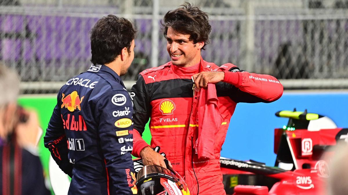 ed Bull's Mexican driver Sergio Perez (L) greets Ferrari's Spanish driver Carlos Sainz Jr after the qualifying session on the eve of the 2022 Saudi Arabia Formula One Grand Prix at the Jeddah Corniche Circuit on March 26, 2022. (Photo by ANDREJ ISAKOVIC / AFP)