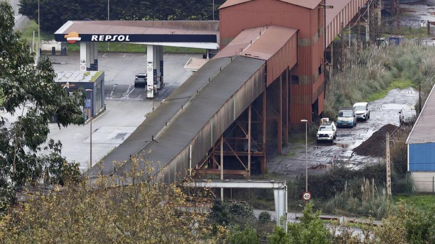 Vehículos junto a una de las torres por las que acceden los operarios a la galería incendiada que se está reparando. | MARCOS LEÓN