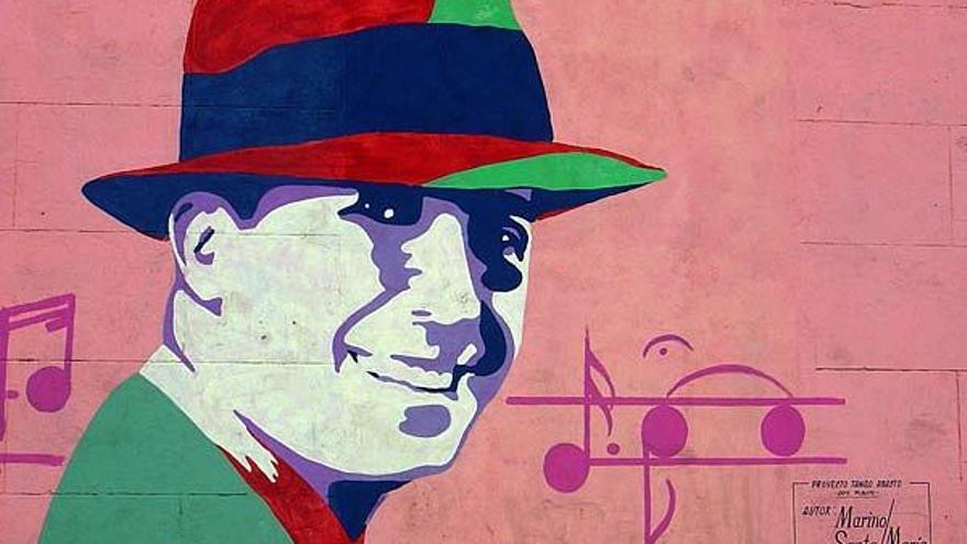 Un mural hecho en una pared con el rostro de Gardel