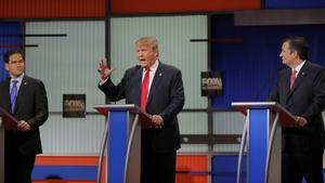 Republican U.S. presidential candidates Senator Marco Rubio (L) and Senator Ted Cruz (R) listen to businessman Donald Trump during the Fox Business Network Republican presidential candidates debate in North Charleston, South Carolina January 14, 2016. REUTERS/Chris Keane