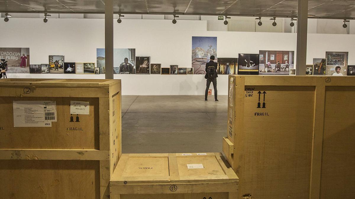 Cajas con fotografías guardadas se exponen junto a las 75 imágenes colgadas en Las Cigarreras de la muestra La línea pródiga, de Cristina de Middel, en PhotoAlicante. | PILAR CORTÉS