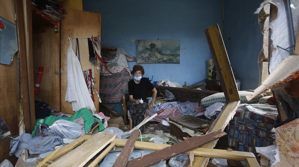 zentauroepp54397698 topshot   a woman stands in the rubble in her damaged house 200807174253