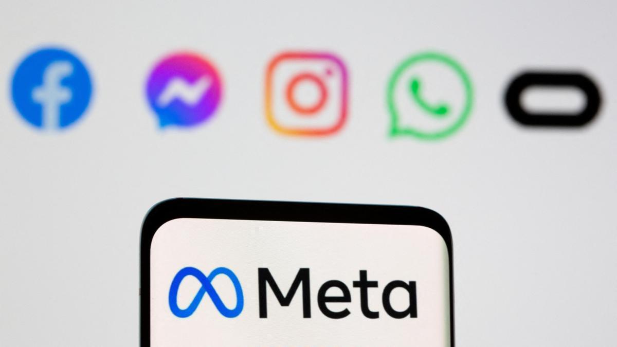 FILE PHOTO: The Meta logo is seen on smartphone in front of displayed logo of Facebook, Messenger, Instagram, WhatsApp, Oculus in this illustration taken